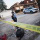 A Chicago police officer guards the perimeter of a crime scene where six people were found slain inside a home on the city's Southwest Side on Feb. 4, 2016.
Scott Olson/Getty Images